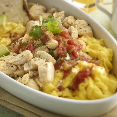 Shredded chicken breadfast bowl with eggs, salsa, avocado, and tortillas