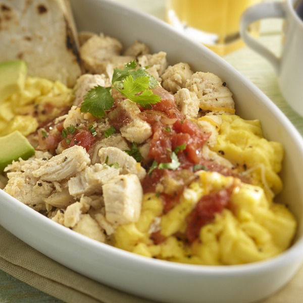 Shredded chicken breakfast bowl with eggs, salsa, avocado, and tortilla