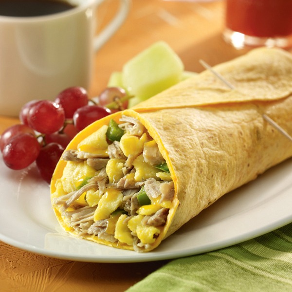 Carnitas breakfast burrito with grapes and melon