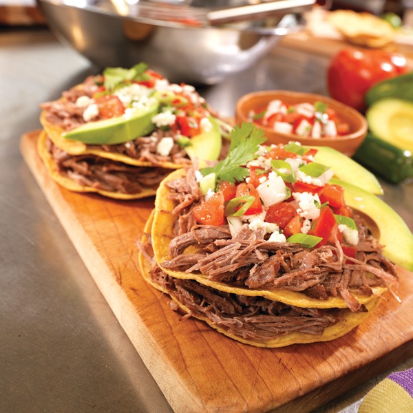 Mexican pot roast tostadas on a tray