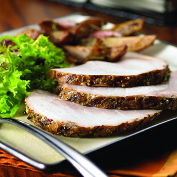 Herb crusted pork roast slices on a plate