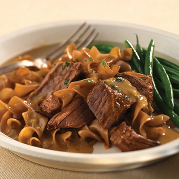 All natural pot roast stroganoff in a bowl with green beans