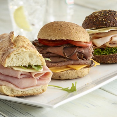 Sliced ham, turkey, and beef sliders on a plate