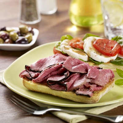 Open-faced beef caprese sandwich on a plate