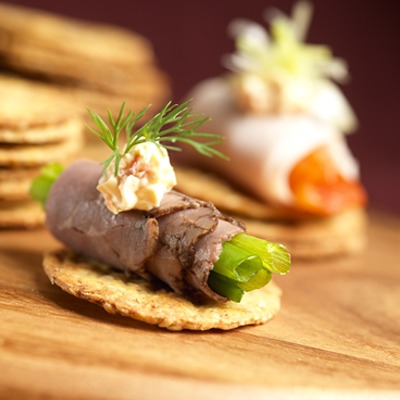 Rolled beef and cream cheese appetizer on a cracker