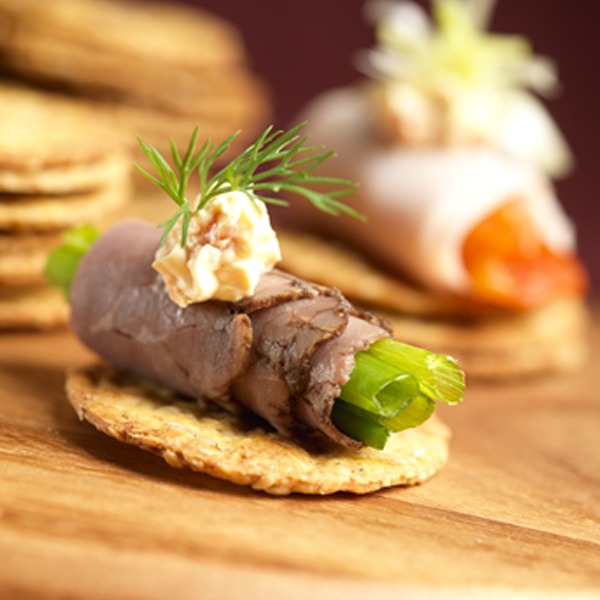 Rolled beef and cream cheese appetizer on a cracker