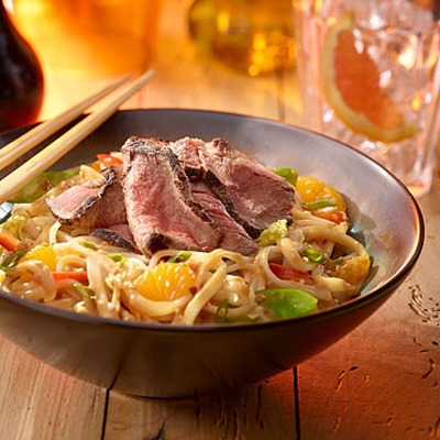 Sirloin Asian noodle bowl with peanut dressing and chopsticks