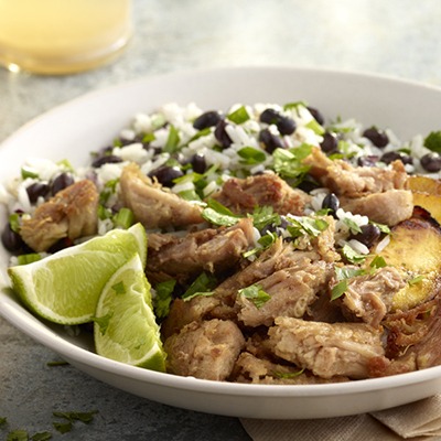 Cuban shredded pork in a bowl with black beans and rice