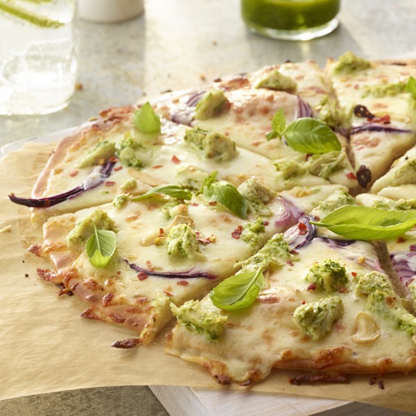 Shredded chicken pesto pizza on a tray