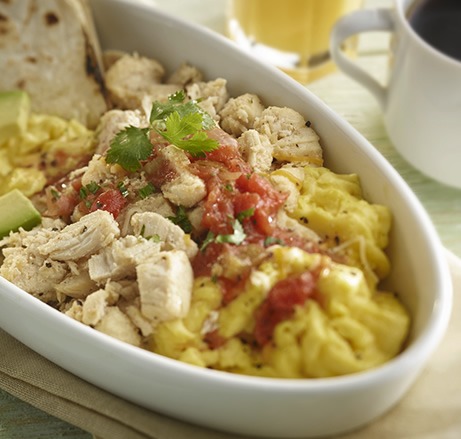 Shredded chicken breakfast bowl with eggs, salsa, avocado, and tortillas