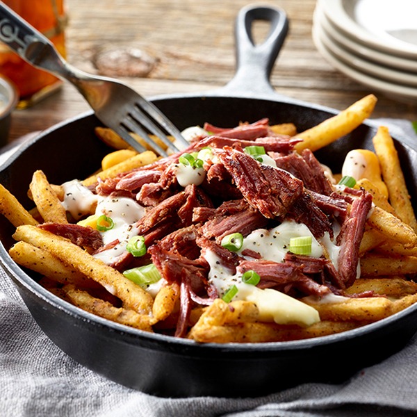 Corned beef poutine in a skillet